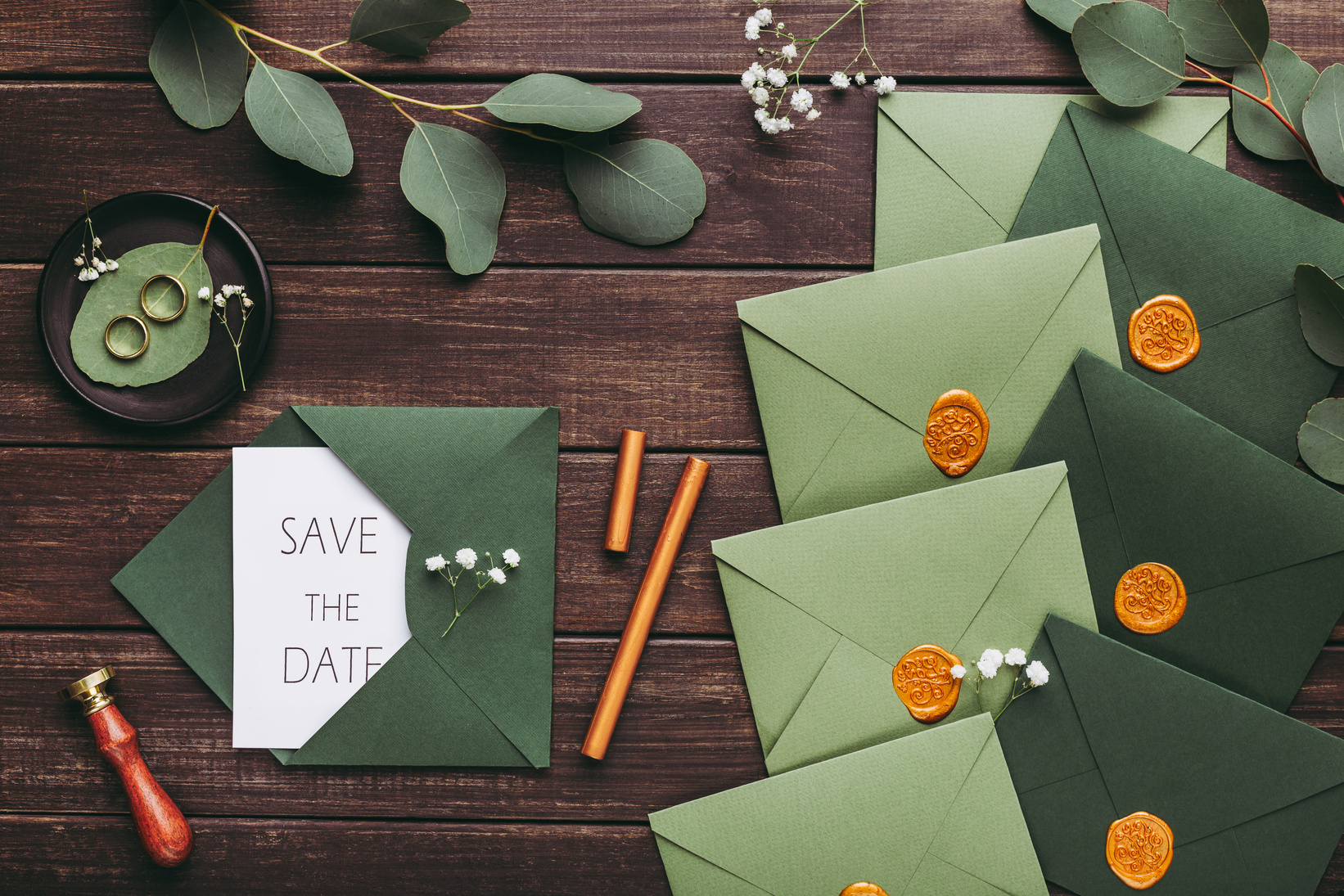 Green modern envelopes with creative wedding invitations